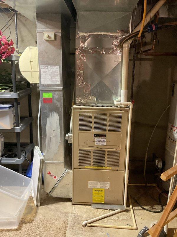 # Sales Estimate - HVAC System Evaluation

Responded to service call for 28-year-old Amana air conditioning system not cooling properly, with fan running but no cold air output. Performed comprehensive diagnostic evaluation of both indoor furnace unit located in basement utility area and outdoor condensing unit. Documented existing equipment configuration with metal ductwork connections and system specifications. Identified refrigerant leak as primary concern affecting cooling performance. Assessed overall system condition considering age and operational status of equipment. Provided detailed estimate for repair options and replacement recommendations based on system age, efficiency considerations, and current refrigerant regulations. Photographed equipment nameplates and installation for reference documentation.