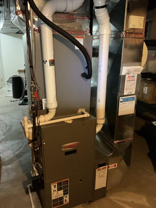 Responded to no cooling complaint on residential AC system. Upon arrival, performed system diagnostics on Lennox HVAC equipment installed in basement. Inspected furnace, air handler, refrigerant lines, condensate drainage system, and electrical connections. Verified airflow, checked thermostat operation, and assessed overall system performance. Documented equipment condition with photos showing installation layout, refrigerant line insulation, PVC condensate piping, and associated components. Customer advised of findings and system operational status.