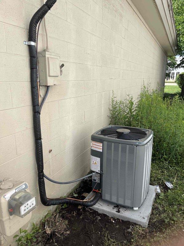 Completed full HVAC system replacement including outdoor condensing unit and indoor air handler. Installed new Goodman brand equipment with proper electrical disconnect, refrigerant line sets, and condensate drainage. Outdoor unit mounted on concrete pad with secure line set routing along exterior wall using appropriate conduit and mounting hardware. Indoor installation positioned in utility closet with metallic supply ductwork connections. All electrical connections completed to code with proper disconnect box installation. System tested and verified operational upon completion.
