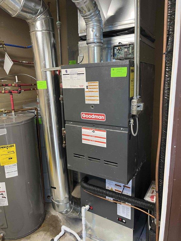 Completed full HVAC system replacement including outdoor condensing unit and indoor air handler. Installed new Goodman brand equipment with proper electrical disconnect, refrigerant line sets, and condensate drainage. Outdoor unit mounted on concrete pad with secure line set routing along exterior wall using appropriate conduit and mounting hardware. Indoor installation positioned in utility closet with metallic supply ductwork connections. All electrical connections completed to code with proper disconnect box installation. System tested and verified operational upon completion.