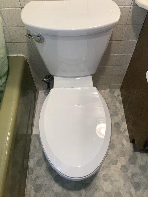 Completed toilet replacement in residential bathroom, removing existing unit and installing new white porcelain toilet with chrome flush lever. Reconnected water supply line with braided stainless steel flex hose to wall-mounted shut-off valve, ensuring proper seal and functionality. Replaced tub spout as quoted. Tested toilet for proper flush operation, verified no leaks at supply connection and base seal, and confirmed stable mounting to floor. Cleaned work area and removed old fixtures from premises.