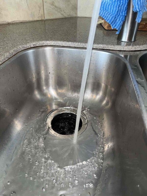 Responded to service call for non-functional garbage disposal. Upon inspection, found InSinkErator 3/4 HP Advanced Series unit installed under kitchen sink. Performed diagnostic assessment and cleared obstruction from disposal using appropriate extraction tools. Tested unit operation to confirm proper functionality and verified all electrical connections and plumbing discharge lines were secure and operating correctly.