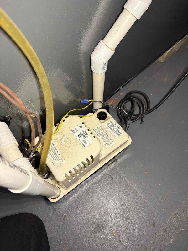 Responded to service call for air conditioning unit cooling properly but experiencing water leakage. Upon inspection, found condensate drainage system requiring attention. Serviced and verified proper operation of condensate pump unit connected to air handler, ensuring all PVC drainage lines were clear and functioning correctly. Confirmed pump discharge and drain pan were operating as designed to prevent future water overflow issues.
