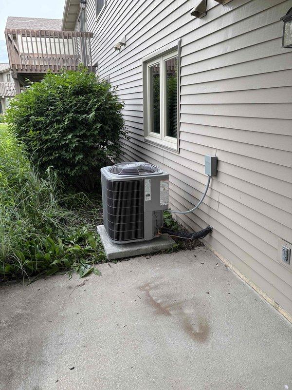 Completed full HVAC system installation including new Carrier furnace unit in basement utility area and exterior condensing unit on concrete pad. Installed vertical ductwork with proper metallic tape sealing, routed refrigerant lines and electrical conduit through exterior wall via PVC housing, and verified all connections between indoor and outdoor components. System commissioned and operational with proper airflow and refrigerant charge confirmed.