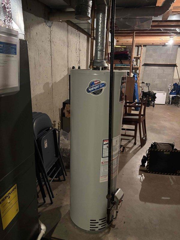 Responded to service call for 14-year-old Bradford White water heater producing only lukewarm water. Upon inspection, performed diagnostic assessment of unit and verified operational status of all components including heating elements, thermostat settings, and gas supply connections. Documented existing installation with measurements and photographic evidence of unit condition and surrounding mechanical systems. Identified age-related performance degradation as contributing factor to reduced water temperature output.