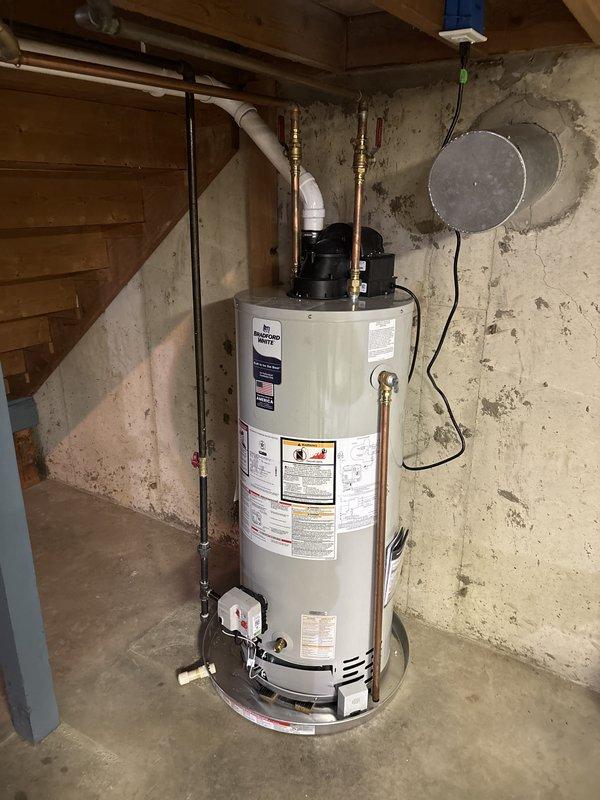 Completed full HVAC system installation including furnace, air conditioning unit, and water heater replacement. Installed outdoor AC condenser unit on concrete pad with proper electrical disconnect, refrigerant line set, and PVC condensate drainage connected to exterior wall. Replaced water heater in basement utility area with new unit, connecting copper supply lines with brass fittings, pressure relief valve, and proper venting. All equipment installed per manufacturer specifications and local code requirements, with systems tested and operational upon completion.