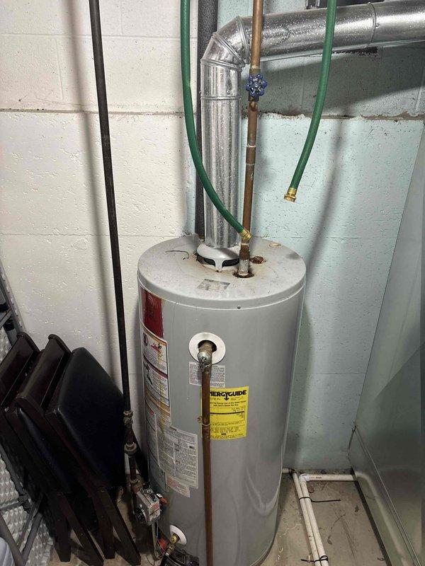 Responded to no hot water complaint and confirmed existing residential water heater was inoperative. Documented current unit installation including all plumbing connections, piping configuration, and utility room conditions. Provided estimate for complete water heater replacement with new unit to restore hot water service.
