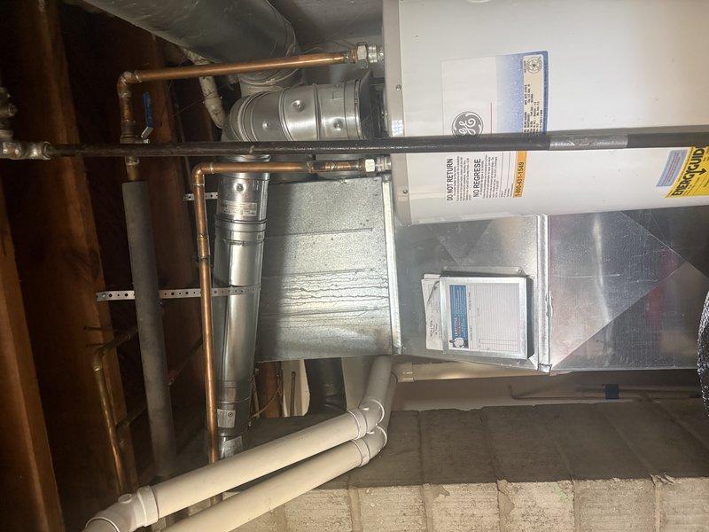 Completed installation of a 50-gallon Bradford White natural gas water heater with natural draft venting in tall configuration. Connected all copper supply lines, gas piping, and venting components to existing infrastructure without requiring chimney liner modification. Unit is fully operational with proper combustion air supply and all safety controls verified.