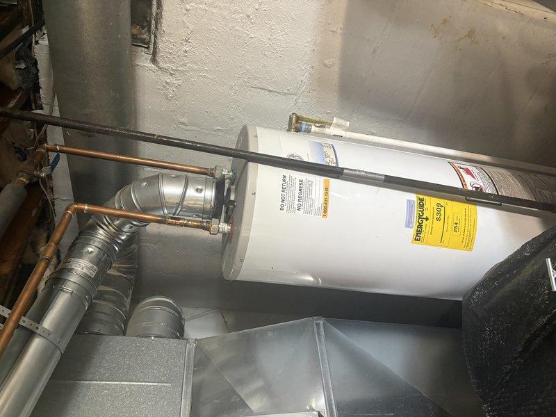 Completed installation of a 50-gallon Bradford White natural gas water heater with natural draft venting in tall configuration. Connected all copper supply lines, gas piping, and venting components to existing infrastructure without requiring chimney liner modification. Unit is fully operational with proper combustion air supply and all safety controls verified.