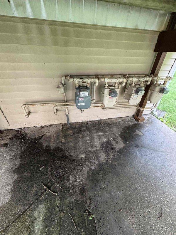 Conducted site assessment for gas line installation to accommodate new gas stove. Documented existing utility infrastructure including water heater specifications and exterior gas meter configuration. Provided estimate for required gas line installation work.