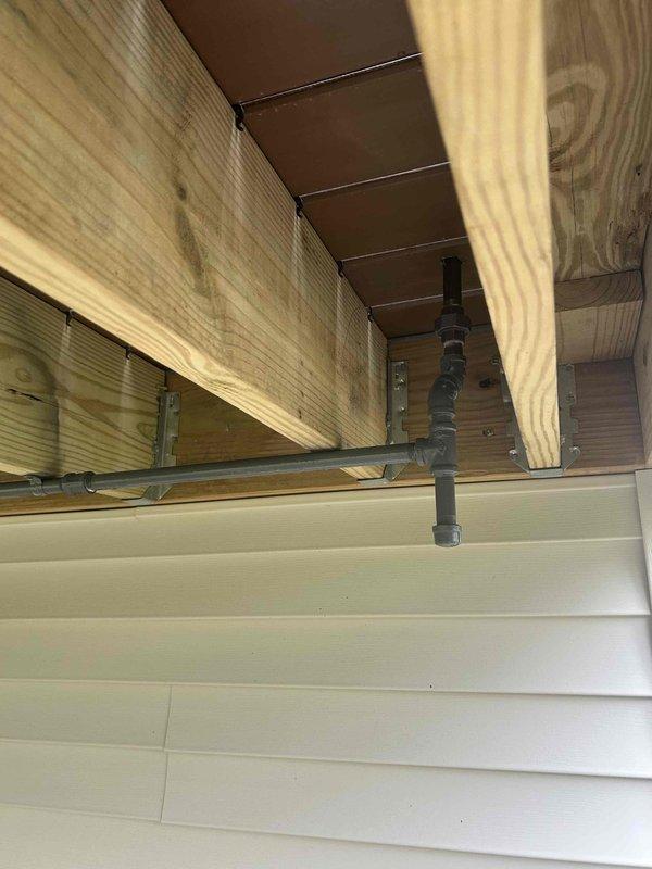 Installed new gas line for outdoor grill application. Routed black iron pipe through basement ceiling joists and secured with appropriate mounting brackets and supports. Completed installation per code requirements with all connections tested and verified for proper operation.