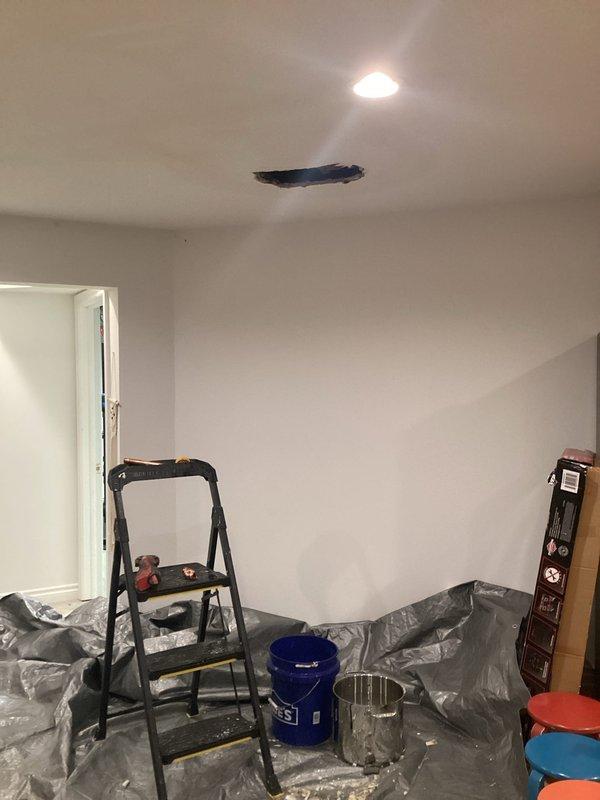 Responded to active plumbing leak in 30-year-old residential property causing visible water damage to interior drywall and ceiling. Upon arrival, confirmed ongoing leak had been present for several months and was localized to one area of the home. Conducted thorough investigation to identify leak source, tracing plumbing lines from affected ceiling area to basement mechanical room. 

Documented existing damage with photographs showing compromised ceiling with exposed opening and water-stained materials. Protected work area with plastic sheeting to prevent further damage during diagnostic and repair process. Inspected basement plumbing infrastructure, focusing on copper supply lines, water heater connections, and associated piping systems. Identified oxidation and discoloration on copper piping near water heater, indicating potential leak point at aged pipe joints or fittings.

Assessed integrity of plumbing connections, valves, and horizontal pipe runs servicing upper floor where ceili