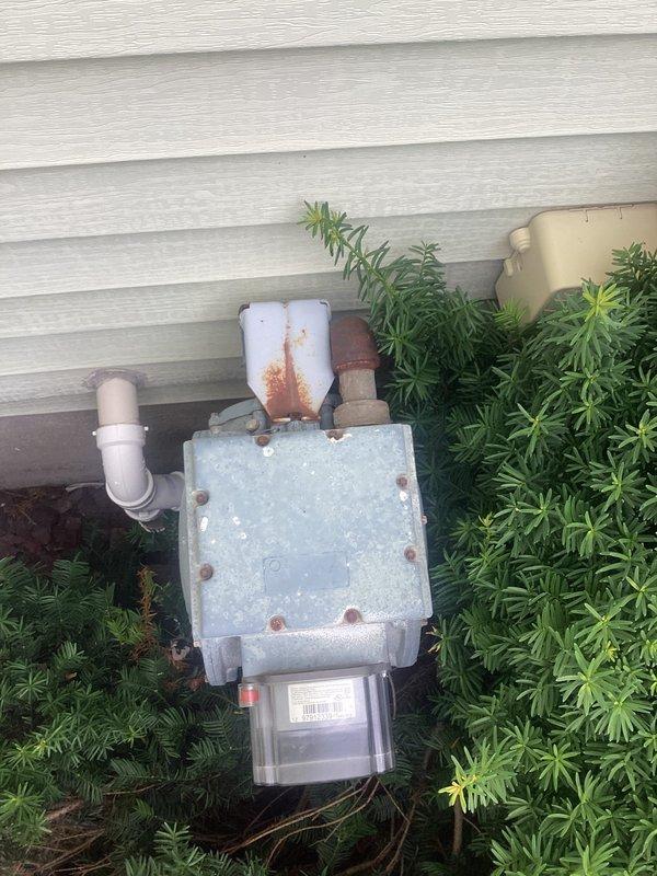 Conducted site assessment and provided project estimate for installation of natural gas line to service pool heater. Evaluated existing gas meter and utility connections mounted on exterior wall, noting current infrastructure including weathered meter enclosure, gas piping, and proximity to irrigation control system. Assessed routing requirements from gas meter location through landscaping area to proposed pool heater installation point. Documented existing conditions including pipe penetrations, utility box placement, and surrounding vegetation that will require consideration during installation. Photographed current gas service equipment and proposed work area to support accurate material takeoff and labor estimates for the gas line extension project.