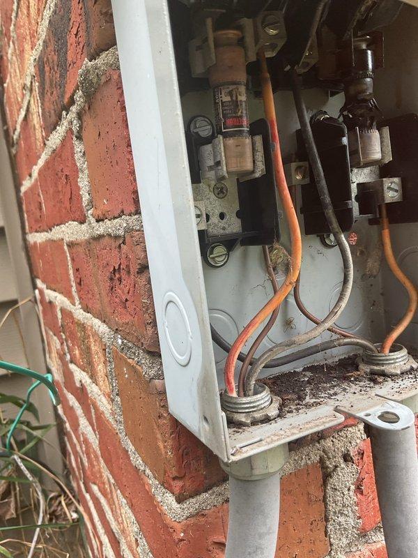 Responded to no-cooling call on 15-year-old air conditioning system following recent storm. Upon arrival, confirmed outdoor unit (compressor and condenser fan) not operating while indoor air handler ran normally and thermostat called for cooling. Inspected exterior disconnect box and found visible signs of age, weathering, and oxidation on electrical components and connections. Observed deteriorated wiring conditions with accumulated dirt and grime throughout the disconnect assembly. Given the unit's age, extent of electrical component degradation, and post-storm failure, recommended system replacement as most cost-effective solution. Documented existing conditions with photographs of disconnect box interior showing aged wiring, oxidized connections, and overall component deterioration. Customer advised of findings and replacement options for improved reliability and efficiency.