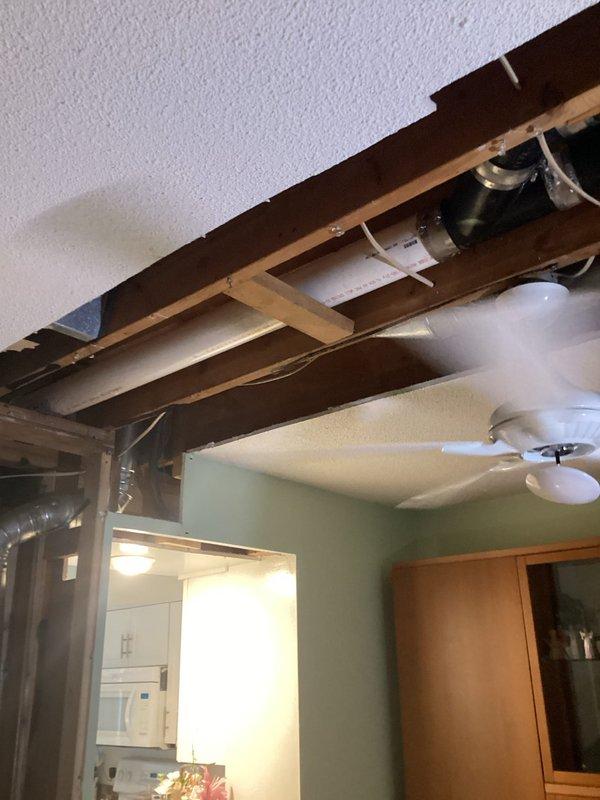 Completed cast iron drain pipe replacement in basement ceiling area. Removed damaged section of cast iron waste line, installed new PVC drainage piping with proper fittings and supports, and secured all connections according to code requirements. Access opening was created through ceiling drywall to reach the affected plumbing system, with all mechanical components properly reinstalled and secured upon completion.