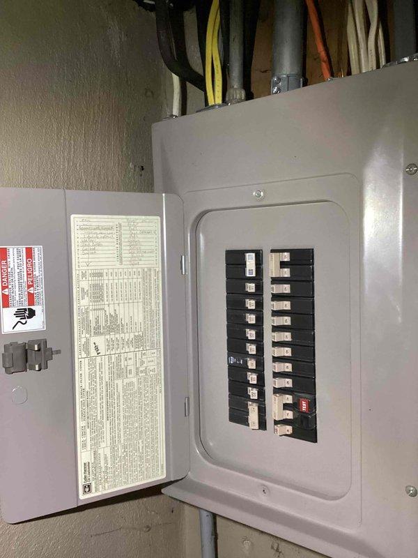 Completed estimate for replacement of 30-year-old Heil furnace and air conditioning system. Evaluated existing electrical panel and circuit breaker configuration to verify adequate capacity for new HVAC equipment installation, documenting current electrical infrastructure with two rows of breakers and associated conduit routing for project planning purposes.