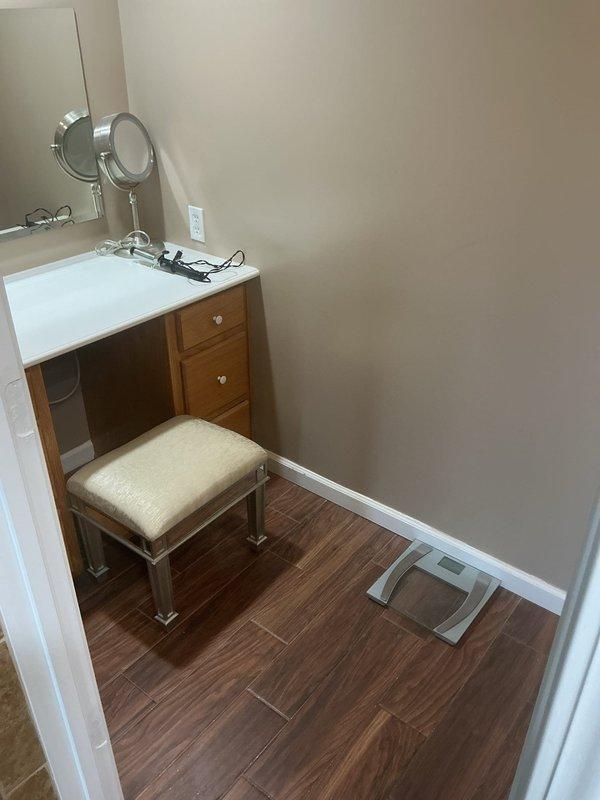 Provided project estimate for freestanding tub installation in a 20-year-old residential property. Assessed existing bathroom space including vanity area with laminate flooring and evaluated subfloor access point showing current plumbing infrastructure with PVC drainage lines, copper supply lines, and HVAC ductwork. Documented site conditions and existing utility routing to prepare comprehensive installation proposal for the requested bathtub replacement.