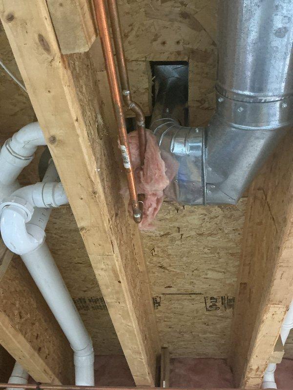 Provided project estimate for freestanding tub installation in a 20-year-old residential property. Assessed existing bathroom space including vanity area with laminate flooring and evaluated subfloor access point showing current plumbing infrastructure with PVC drainage lines, copper supply lines, and HVAC ductwork. Documented site conditions and existing utility routing to prepare comprehensive installation proposal for the requested bathtub replacement.