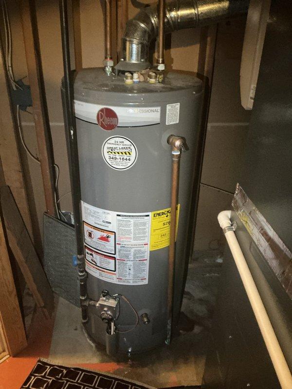 Responded to water heater leak beneath unit. Upon arrival, inspected 10-year-old Rheem Professional natural gas water heater manufactured February 2015. Identified source of water leakage at base of tank, indicating internal tank failure consistent with age and normal wear. Documented unit condition with photographs showing tank corrosion and active leak. Advised that tank replacement is necessary as internal tank leaks cannot be repaired and unit has reached expected service life.