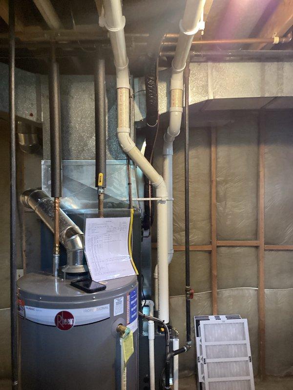 Completed full system installation of new furnace and air conditioning unit in residential basement utility area. Installed HVAC equipment with proper ductwork routing, including black flexible duct connections and metallic exhaust flue. System secured with financing approval and completed as same-day booking service.