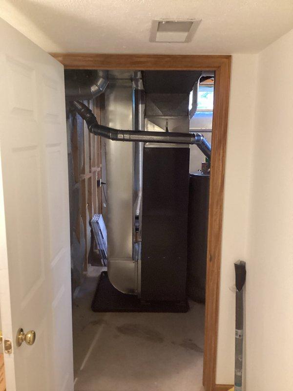 Completed full system installation of new furnace and air conditioning unit in residential basement utility area. Installed HVAC equipment with proper ductwork routing, including black flexible duct connections and metallic exhaust flue. System secured with financing approval and completed as same-day booking service.