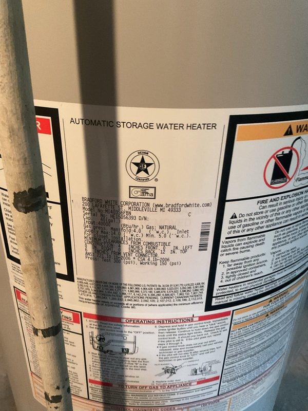 Completed on-site estimate for water heater replacement. Inspected existing Bradford White automatic storage water heater and documented current installation conditions including gas connections, venting system with white PVC piping, copper supply lines, and electrical connections. Photographed unit specifications, manufacturer labels, safety warnings, and overall installation setup to provide accurate replacement recommendations and ensure proper sizing for new equipment.