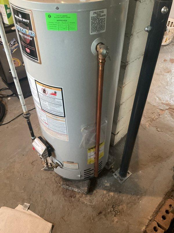 Completed on-site estimate for water heater replacement. Inspected existing Bradford White automatic storage water heater and documented current installation conditions including gas connections, venting system with white PVC piping, copper supply lines, and electrical connections. Photographed unit specifications, manufacturer labels, safety warnings, and overall installation setup to provide accurate replacement recommendations and ensure proper sizing for new equipment.