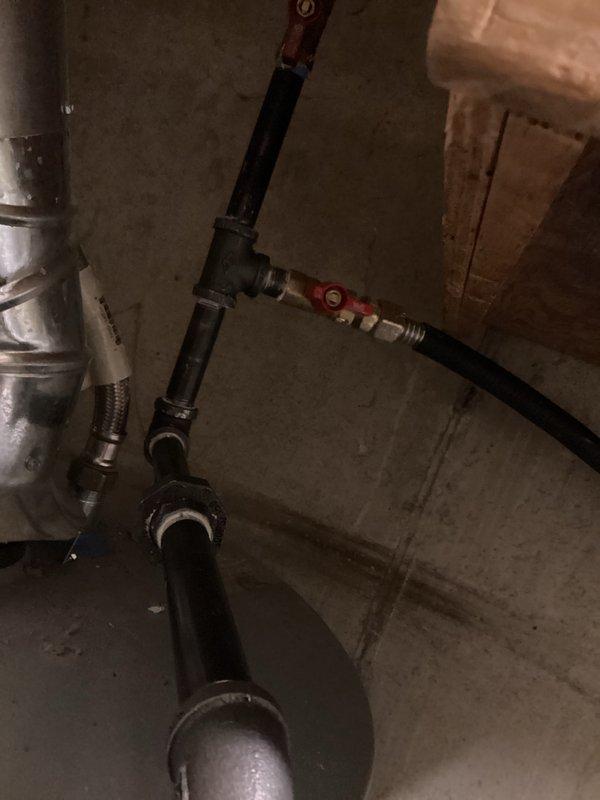 Completed gas dryer installation including new black iron gas line with shutoff valve and proper venting system. Installed flexible gas connector with red-handled shutoff valve, routed metallic dryer vent ductwork with proper connections, and verified all connections for safe operation in basement utility area.