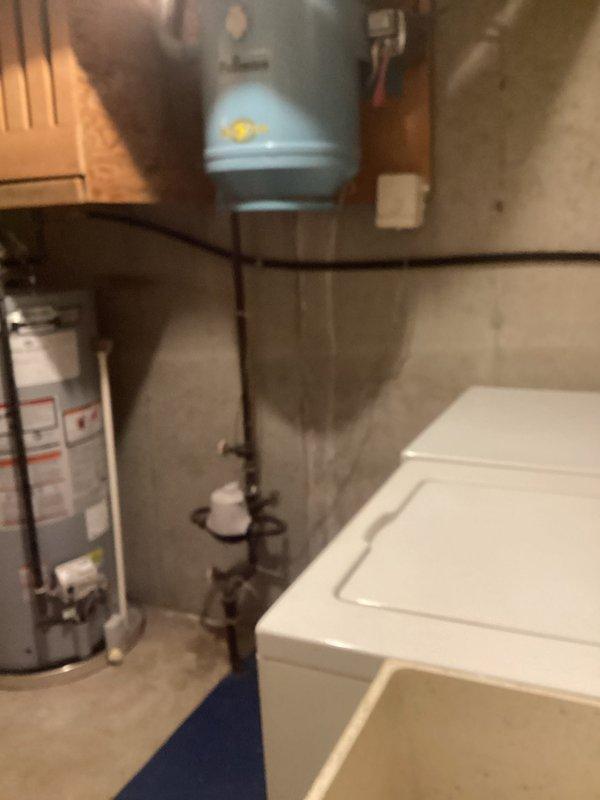 Completed gas dryer installation including new black iron gas line with shutoff valve and proper venting system. Installed flexible gas connector with red-handled shutoff valve, routed metallic dryer vent ductwork with proper connections, and verified all connections for safe operation in basement utility area.