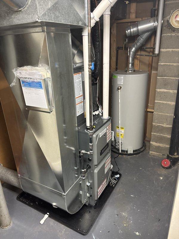 Completed full HVAC system installation including new furnace and air conditioning unit in basement utility area. System was properly positioned, all ductwork connections secured, and refrigerant lines installed with factory charge of 8 oz confirmed. All equipment tested and verified operational upon completion.