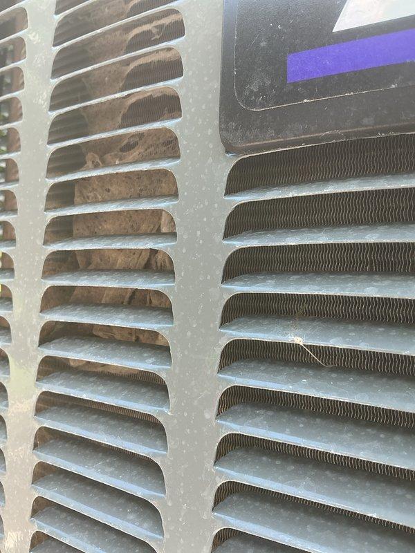 Completed annual cooling maintenance on EnergiAir system. Inspected condenser coils and heat exchanger components, noting moderate dust and debris accumulation on fins and louvers consistent with normal operation. Documented equipment condition with photos showing functional components with typical wear patterns. System operational at time of inspection.