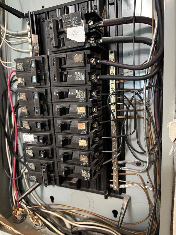 Conducted comprehensive electrical panel evaluation for potential upgrade assessment. Documented existing panel configuration showing dual-column circuit breaker arrangement with mixed wire gauges and multiple circuit connections, including dedicated dishwasher circuit. Panel inspection revealed standard residential breaker installation with main disconnect, bus bar connections, and various amperage-rated breakers serving the electrical distribution system.