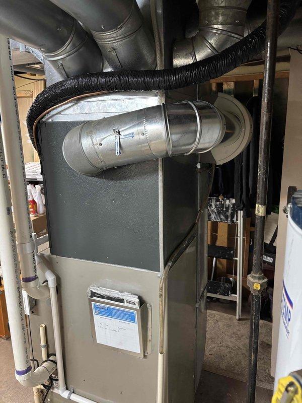 Completed full AC replacement installation as a same-day service call. Replaced failed dual-fuse disconnect assembly showing significant copper oxidation and discoloration, which had compromised electrical connections to the outdoor condensing unit. Installed new air conditioning system with proper electrical connections, verified all safety disconnects, and ensured proper integration with existing furnace and ductwork infrastructure in mechanical room.