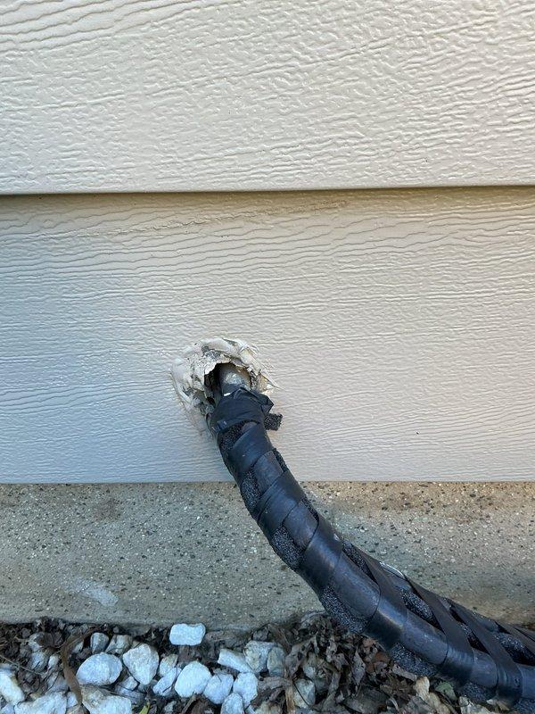 Completed annual cooling maintenance inspection on 2017 air conditioning system. Performed comprehensive tune-up including inspection of dual blower motor assembly, verified proper operation of condensate drain pan with active drainage present, and confirmed exterior refrigerant line penetration through building envelope with adequate foam sealant protection. All components operating within normal parameters with typical wear for equipment age.