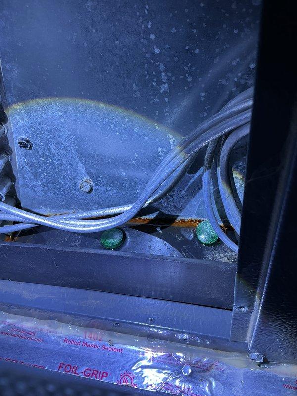 Completed annual cooling maintenance on 2017 EnergiAir system under 5-year tune-up agreement. Inspected condensing unit model CAP050400440CT, verified refrigerant lines and connections showing normal condensation patterns, documented equipment condition with moisture present on components indicating proper operation. Applied foil grip mastic sealant to seal penetrations, checked electrical connections and wiring routing, confirmed all manufacturer labels and identification tags legible for future service reference.