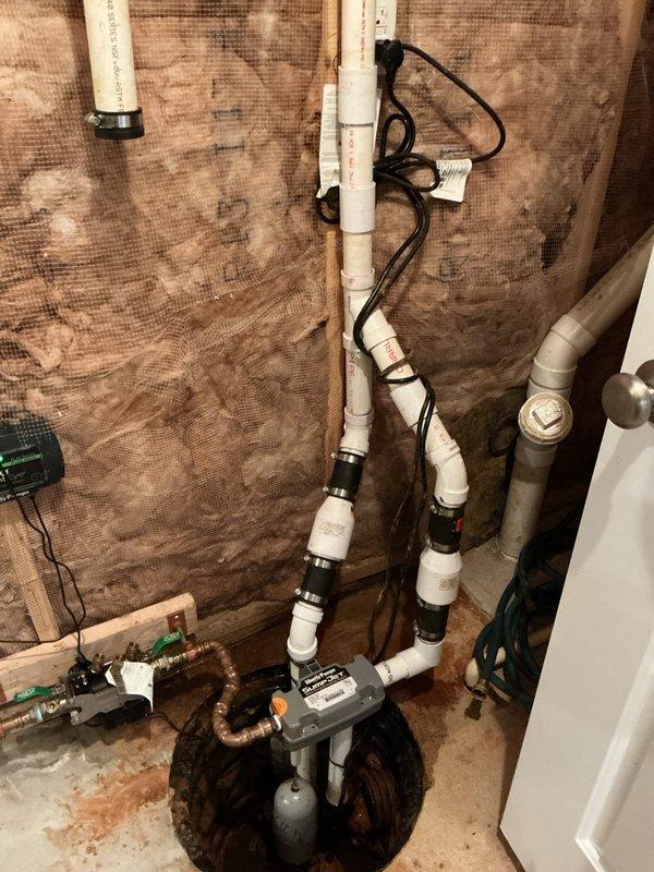 Responded to service call regarding backup sump pump reported as non-functional following previous installation visit. Upon inspection, diagnosed and resolved operational issues with the backup pump system. Verified proper pump operation, checked electrical connections, and tested the complete sump pump assembly including primary and backup units to ensure reliable functionality and proper water discharge through the vertical PVC drainage system.
