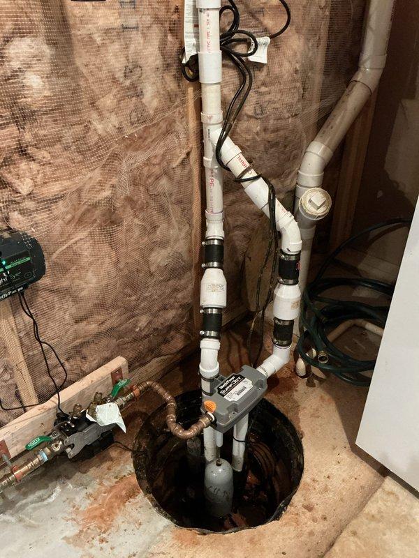 Responded to service call regarding backup sump pump reported as non-functional following previous installation visit. Upon inspection, diagnosed and resolved operational issues with the backup pump system. Verified proper pump operation, checked electrical connections, and tested the complete sump pump assembly including primary and backup units to ensure reliable functionality and proper water discharge through the vertical PVC drainage system.