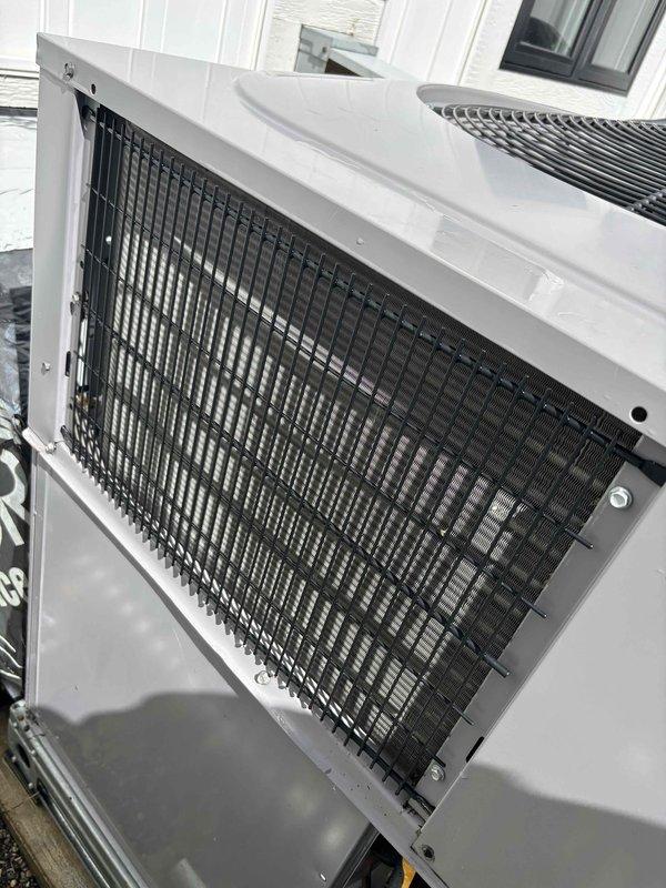 Responded to noise complaint on 5-year-old EnergiAir HVAC system that developed excessive operational noise following recent repair work. Inspected outdoor condenser units, verified proper fan operation and mounting stability, and documented equipment condition with photographs. System confirmed heating and cooling properly despite noise issue; recommended monitoring for potential loose components or mounting hardware that may require adjustment.
