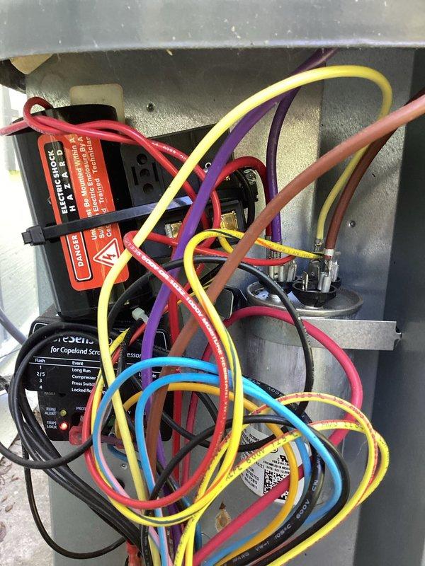 Completed annual AC tune-up and cooling system inspection. Performed comprehensive evaluation of electrical control panel, verified proper operation of all components including capacitor, control board, and motor connections. Documented system condition with photos showing electrical panel wiring, diagnostic control module, and internal components; all wiring and connections found secure and functioning properly.