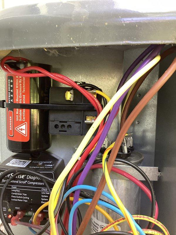Completed annual AC tune-up and cooling system inspection. Performed comprehensive evaluation of electrical control panel, verified proper operation of all components including capacitor, control board, and motor connections. Documented system condition with photos showing electrical panel wiring, diagnostic control module, and internal components; all wiring and connections found secure and functioning properly.