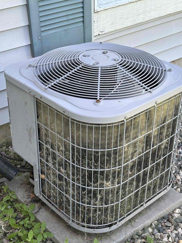 Completed annual cooling maintenance on 11-year-old Carrier air conditioning system. Outdoor condenser unit exhibited heavy accumulation of dirt, dust, pollen, and debris on exterior wire guard panels and condenser coils, indicating extended period without maintenance. Performed comprehensive system inspection and cleaning of condenser coils to restore proper airflow and heat transfer efficiency. Removed substantial buildup from protective wire guards and coil surfaces. Verified fan operation and checked refrigerant pressures. System tested and operating within normal parameters following maintenance procedures.