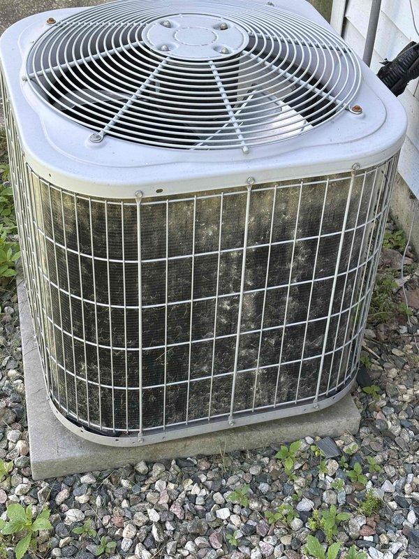 Completed annual cooling maintenance on 11-year-old Carrier air conditioning system. Outdoor condenser unit exhibited heavy accumulation of dirt, dust, pollen, and debris on exterior wire guard panels and condenser coils, indicating extended period without maintenance. Performed comprehensive system inspection and cleaning of condenser coils to restore proper airflow and heat transfer efficiency. Removed substantial buildup from protective wire guards and coil surfaces. Verified fan operation and checked refrigerant pressures. System tested and operating within normal parameters following maintenance procedures.