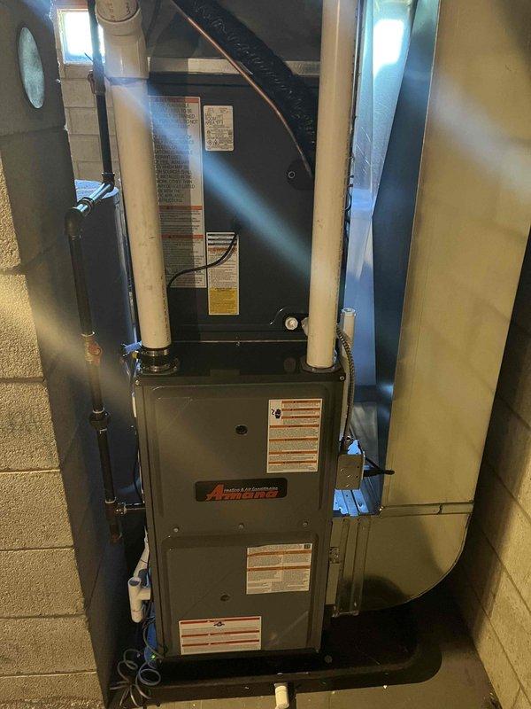 Completed full HVAC system installation including Amana brand furnace and air conditioning condenser unit. Mounted outdoor AC unit on concrete pad with proper refrigerant line connections, electrical conduit, and service access. Installed indoor furnace with integrated air handler/evaporator coil in basement utility area, secured to concrete block wall with appropriate venting and PVC condensate drain lines. Performed system startup, pressure testing with manifold gauges, and verified proper operation of all components. Installation completed with financing documentation processed through Michigan Saves program.