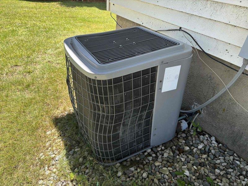 # Frozen Compressor Service Call

Responded to service call for 16-year-old residential air conditioning system with reported frozen and iced-up compressor. Upon arrival, performed visual inspection of outdoor condenser unit and associated components.

## Findings

Found outdoor condenser unit with significant ice accumulation on refrigerant lines and compressor assembly. Unit located on concrete pad with proper clearances maintained. Electrical connections and conduit in acceptable condition. Observed system had been operating under restricted airflow or low refrigerant charge conditions leading to freeze-up.

## Actions Taken

- Shut down system to allow complete ice melt from evaporator coil and refrigerant lines
- Inspected condenser coil fins for debris obstruction and proper airflow
- Examined refrigerant line insulation for deterioration
- Checked condensate drain system for proper operation
- Documented equipment condition with photographs for service records
- Inspected indoor