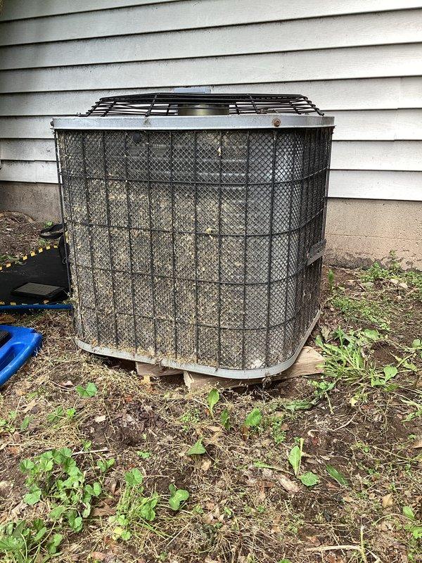 Completed annual cooling maintenance on 23-year-old Aireflo air conditioning system. Performed comprehensive inspection of outdoor condenser unit, which showed significant age-related wear with accumulated dirt and debris on protective mesh cage and components. Inspected electrical contactor and relay assembly, noting weathered condition with visible dust accumulation on terminals and connections. Verified all wire connections at contactor including multiple colored leads to terminal blocks were secure. Checked capacitor and associated electrical components for proper operation. Cleaned condenser coil and removed debris from unit exterior and surrounding area. Tested system operation and confirmed proper cooling function. Unit operational despite advanced age, though customer advised of system condition and potential need for future replacement consideration given equipment age and visible component deterioration.