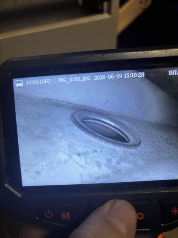 Responded to service call regarding venting options for existing furnace during roof replacement project. Performed visual inspection of furnace unit and examined current venting configuration using borescope camera to assess vent pipe condition and routing. Inspected electrical components, wiring connections, and overall unit condition to determine equipment age and compatibility with alternative venting methods. Documented existing through-roof vent termination and internal vent connection point. Provided customer with professional recommendations on whether current roof venting could be maintained during re-roofing or if conversion to side-wall venting would be required. Discussed equipment age considerations and potential need for furnace replacement if side-venting conversion becomes necessary. Captured photographic documentation of unit interior, electrical components, and vent inspection for customer records and future reference.