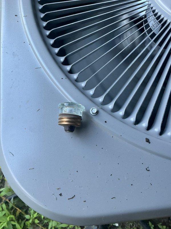 Responded to a no cooling call and performed diagnostic inspection of outdoor heat pump unit and electrical disconnect. Upon arrival, inspected outdoor unit which showed normal external condition with typical outdoor debris accumulation on top panel. Verified fan guard and housing integrity were intact. Examined electrical disconnect box mounted on exterior wall, confirmed fuse holders and internal wiring connections were present with proper color-coded conductors. Unit components appeared functional with no visible damage to electrical enclosure or outdoor equipment housing.