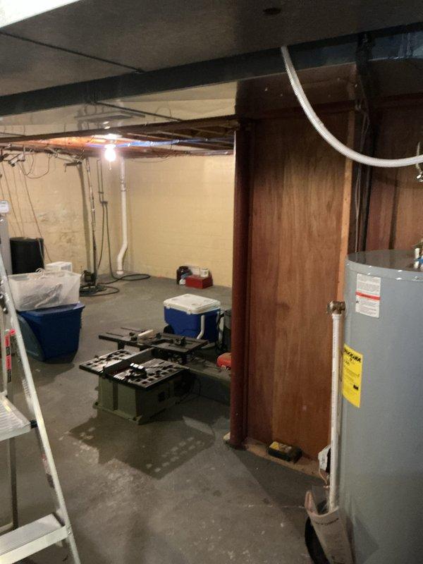 Responded to customer inquiry regarding the feasibility of adding a blower to their existing 6-year-old Lochinvar natural gas water heater, Model GSN05040 400, Serial Number 40000, 50-gallon capacity. Conducted on-site assessment of the unit located in unfinished basement area. Inspected water heater installation, reviewed manufacturer specifications, and evaluated existing venting configuration. Documented current installation with photographs showing unit condition and surrounding workspace. Determined compatibility requirements and provided technical consultation to customer regarding blower addition options for their specific Lochinvar model.