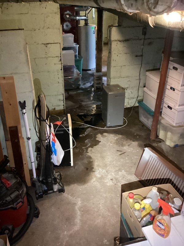 Responded to basement flooding emergency where standing water had accumulated throughout the utility area. Extracted significant volume of water from concrete floor using professional water removal equipment. Addressed drainage system failure that caused the flooding incident. Inspected and assessed condition of affected plumbing infrastructure including water heater, utility equipment, and drainage piping. Identified compromised floor drain as primary source of backup. Cleared obstruction from main drain line and restored proper flow. Verified all mechanical systems remained operational despite water exposure. Documented extensive water damage to walls and floor for insurance purposes.
