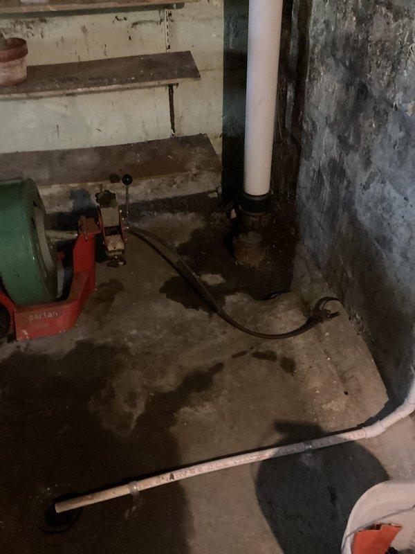 Responded to basement flooding emergency where standing water had accumulated throughout the utility area. Extracted significant volume of water from concrete floor using professional water removal equipment. Addressed drainage system failure that caused the flooding incident. Inspected and assessed condition of affected plumbing infrastructure including water heater, utility equipment, and drainage piping. Identified compromised floor drain as primary source of backup. Cleared obstruction from main drain line and restored proper flow. Verified all mechanical systems remained operational despite water exposure. Documented extensive water damage to walls and floor for insurance purposes.